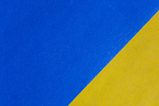 blue and yellow paper color for background. Paper textured abstract background