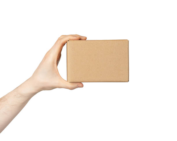 istock cardboard box in male hands isolated on white background 1457644642