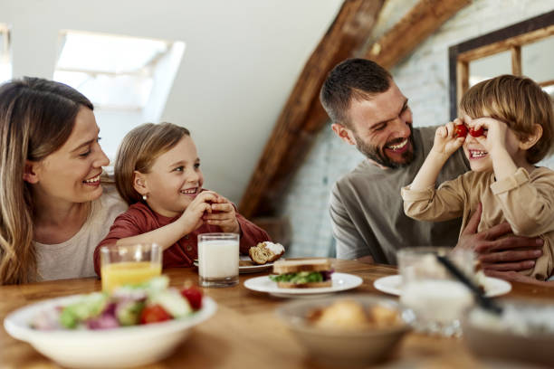 istock Happy family enjoying during breakfast at dining table. 1457644673