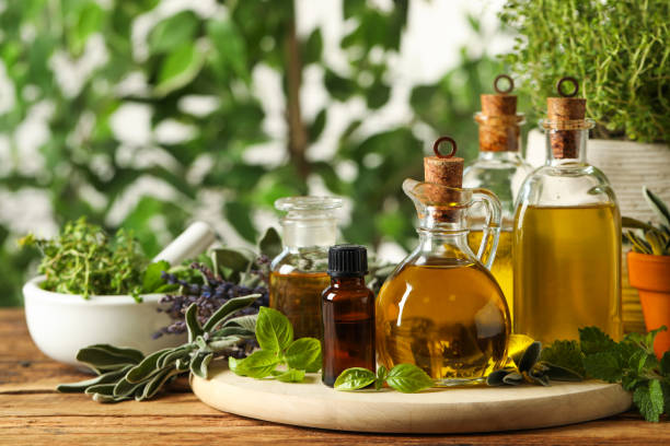 istock Different fresh herbs with oils on wooden table 1457644690