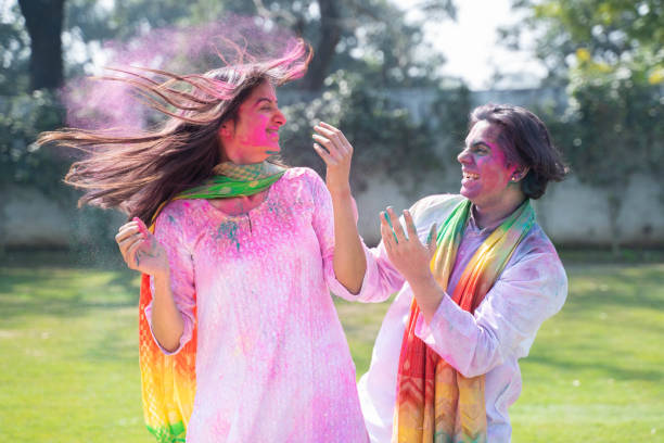 istock Beautiful Indian couple playing Holi with colors 1457647782