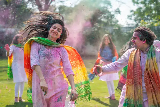 Photo of Indian couple enjoying in a Holi party