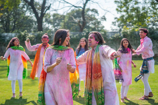 istock Indian couple dancing at a Holi party 1457647828