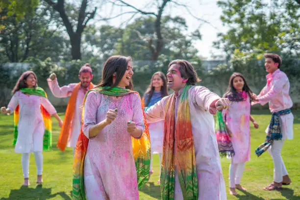 Photo of Indian couple dancing at a Holi party