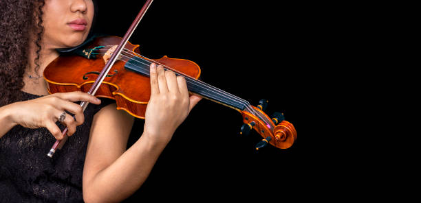 istock professional violinist playing violin with black space on the right. 1457648154