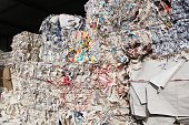Wastepaper compact texture pile for recycling on sorting plant. Technology of reuse materials. Stack of shredded paper