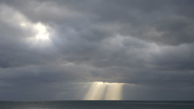 The enchanting and mysterious sunlight shining into the sea clouds of Jeju Island, Korea
