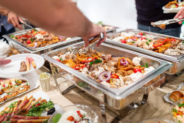 istock Man serving himself from warming tray. Barbecue buffet self service concept. 1457654711