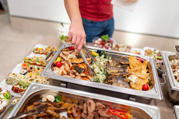 istock Man scooping seafood from warming tray. Health meal buffet lunch. 1457654808