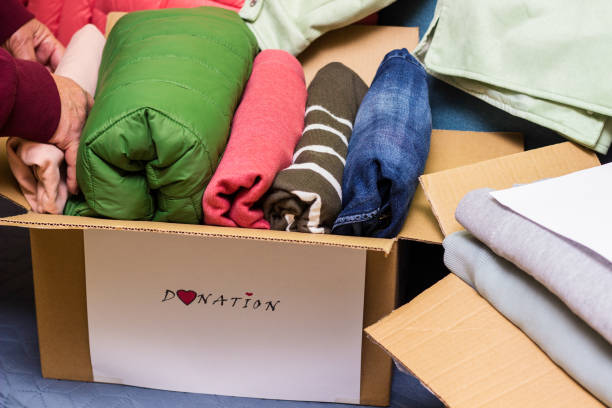 istock Clothes Donation. Box of warm cloth with donate label 1457659242