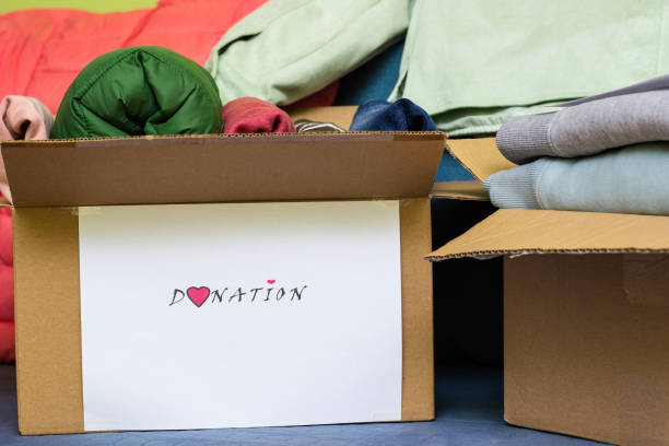 Clothes Donation. Box of warm cloth with donate label stock photo