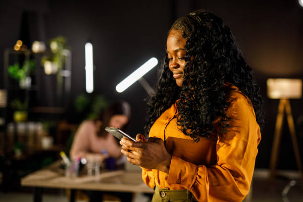 istock Smiling young businesswoman responding to a text message during office break 1457662263