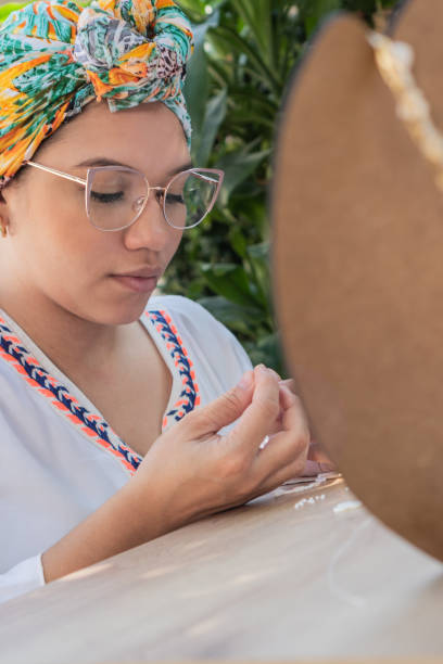 istock Woman making necklaces in her home workshop. 1457662756