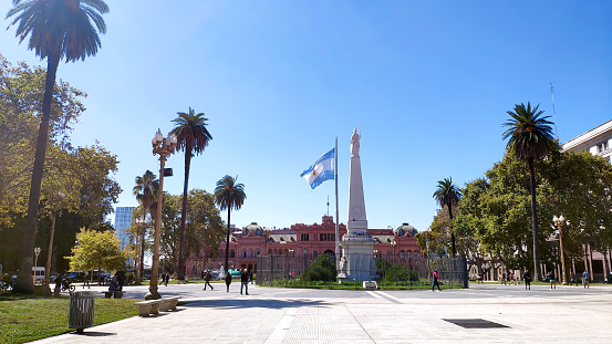 The Piramide de Mayo and Casa Rosada (Pink House) at Plaza de Mayo in Buenos Aires on a sunny day, Argentina.