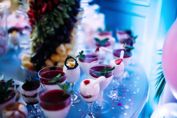 istock Beautifully decorated table with different cakes and sweets.Homemade ice cream with jam chocolate and mint. Sweets on a children's birthday 1457663649