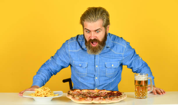 istock Big portion. Friday tradition. Dinner at pub. Hungry man going to eat pizza and drink beer. Finally pizza time. Pizzeria restaurant. Cheerful man bearded hipster eat pizza. Pizza party concept 1457665742