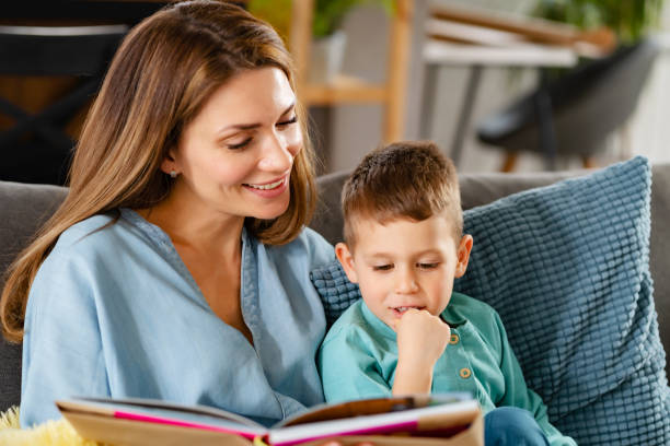 istock Mother reading a book to her young son 1457668017