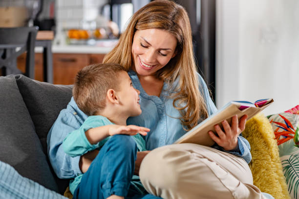 istock Mother reading a book to her young son 1457671468