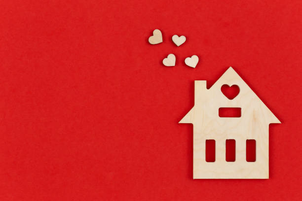 istock Wooden house on a red background, flat lay, space for text. 1457672378