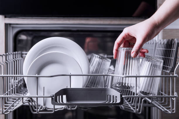istock Open dishwasher with clean cutlery, glasses, dishes inside in the home kitchen 1457672612