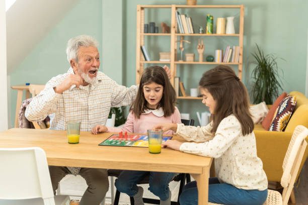 istock Playful grandfather spending time with his granddaughters 1457673052