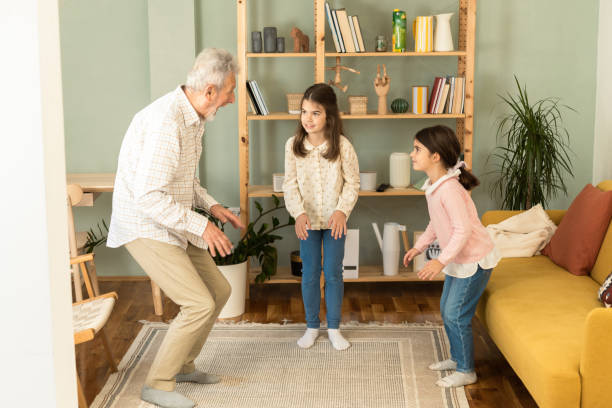 istock Playful grandfather spending time with his granddaughters 1457673057