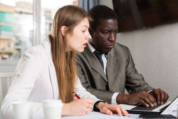 istock Focused coworkers working together 1457675935