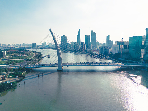 drone view on skyline with modern buildings at riverside in ho chi minh city in the backlit