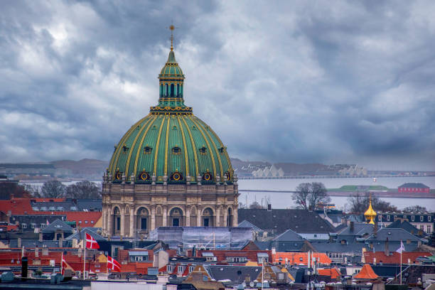 The Marble Church, Copenhagen, Denmark - November 12, 2022: The Marble Church, also known as Frederik's Church, is an Evangelical Lutheran church in Copenhagen, Denmark.  Frederick's Church has the largest church dome in Scandinavia with a span of 31m. The dome rests on 12 columns. The inspiration was probably St. Peter's Basilica in Rome. The church was designed by architect Nicolai Eigtved in 1740 \n\nThe foundation stone was set by king Frederick V on October 31, 1749, but the construction was slowed by budget cuts and the death of Nicolai Eigtved in 1754. In 1770, the original plans for the church were abandoned by Johann Friedrich Struensee. The church was left incomplete and, in spite of several initiatives to complete it, stood as a ruin for nearly 150 years.\n\nIn 1874, Andreas Frederik Krieger, Denmark's Finance Minister at the time, sold the ruins of the uncompleted church and the church square to Carl Frederik Tietgen for 100,000 Rigsdaler — none of which was to be paid in cash — on the condition that Tietgen would build a church in a style similar to the original plans and donate it to the state when complete, while in turn he acquired the rights to subdivide neighboring plots for development.