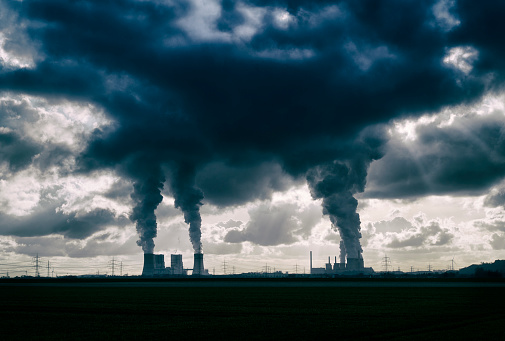 High resolution photograph of two brown-coal fired power plants with pollution, Germany.
