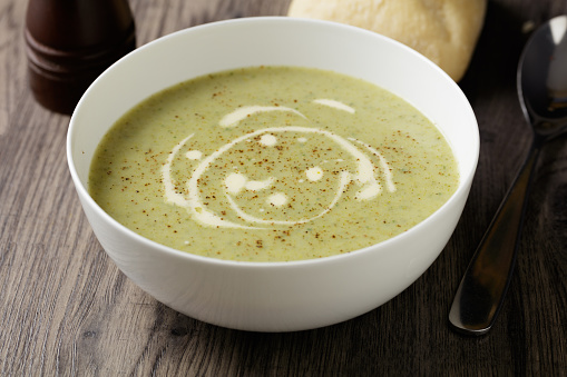 Home-made healthy broccoli and blue cheese soup with crusty bread