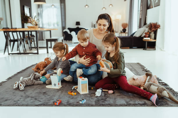 istock Mother playing at home with her three children 1457686071