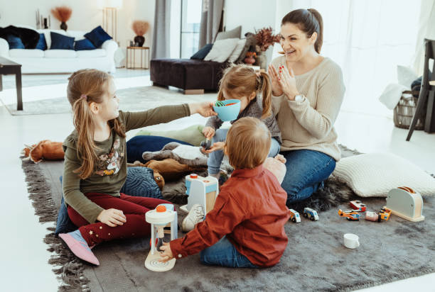 istock Mother playing at home with her three children 1457686128