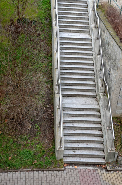 istock staircase with concrete sides at a public building. the safe staircase has two handrails, one with a reduced height for children under 12 at the entrance to the school, drone view, top, point of 1457687637