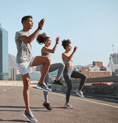 Diversity, fitness friends or runner stretching in city for marathon, running exercise or sports workout. Wellness, teamwork health or group of athlete training for warm up , sport or street race