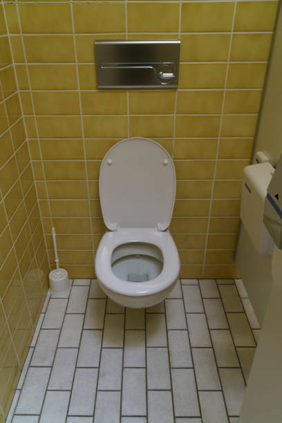 istock ceramic toilet bowl near yellow wall 1457690732
