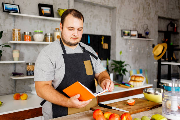 istock Overweight man searching for healthy recipe 1457691121