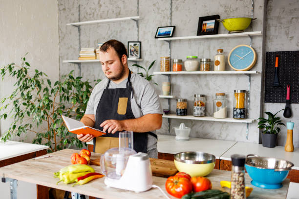 istock Overweight man searching for healthy recipe 1457691123