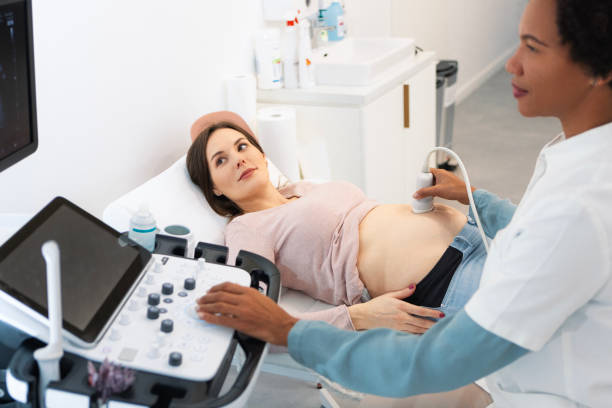 istock Pregnant woman on sonogram prenatal test 1457693352