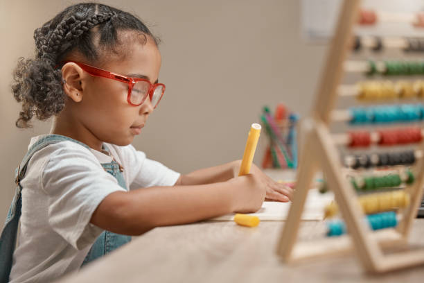 istock Education, girl or student drawing on paper or writing homework in notebook with artistic creativity. Development, learning or kindergarten school child with creative talent, concentration or focus 1457693862