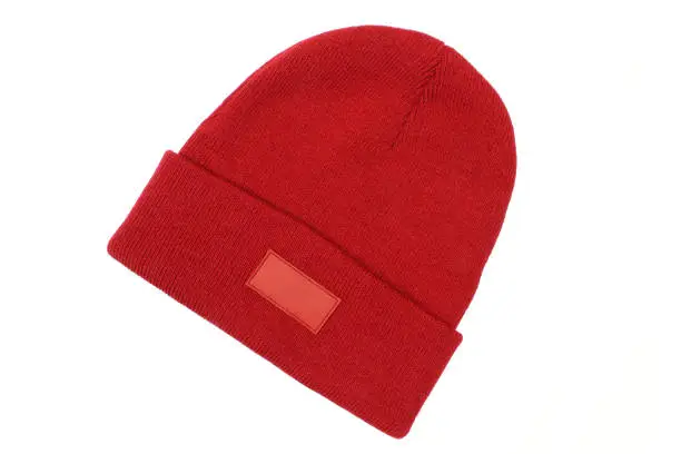 Blank red winter hat for men with blank label template isolated on white background. Classic woolen beanie cap