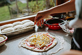 Woman making original italian pizza at home