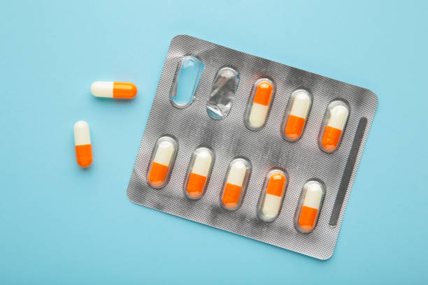 istock Blister pack with medicines on blue background, top view. Dietary supplements, vitamins for health and body tone. Good mood concept. 1457698137
