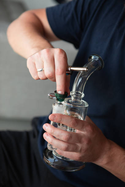 istock Clear glass bong. Smoking marijuana at home. 1457699537