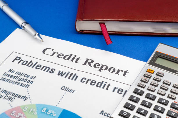 istock Credit report on the blue table and a pen. 1457699927