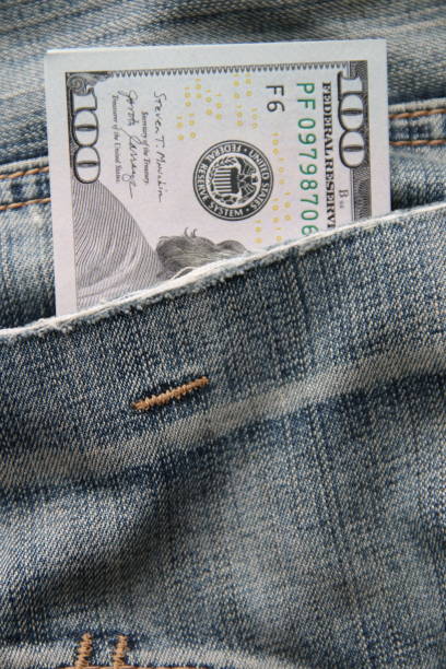 istock Dollar bills in a back pocket of jeans. 1457700832