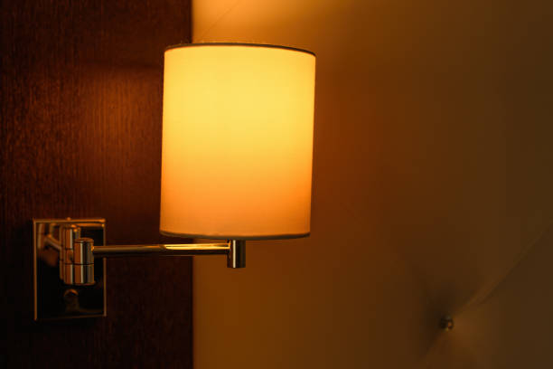 istock Bedside lamp in hotel room mounted on the wall 1457706676