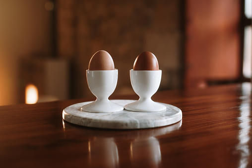 Two eggs on white french porcelain egg cups
