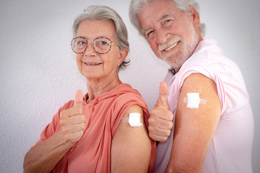 70-year-old Caucasian couple after receiving a booster dose of the covid-19 coronavirus vaccine. Concept of protection, responsibility and healthcare