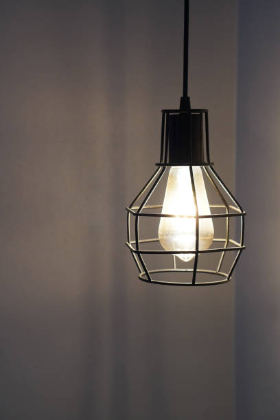 istock closeup black steel Iron lights hang down on a white wall background, object, light, decor, modern, vintage, copy space 1457713309